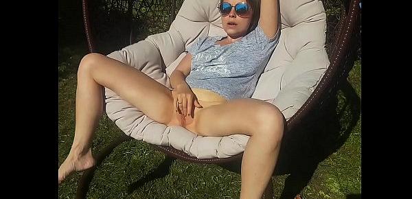 The nasty beauty masturbates her cute pink pussy and squirts in the yard